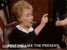A Judge Is Sitting In A Courtroom Pointing At A Person . GIF