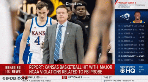 A Kansas Basketball Player And Coach Are Shown On A Cbs Sports Screen GIF