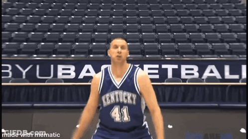 A Kentucky Basketball Player Wearing Number 41 Stands In Front Of An Empty Stadium GIF