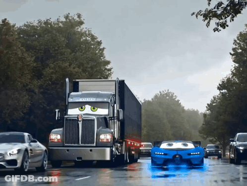 A Kenworth Semi Truck Driving Down A Wet Road GIF