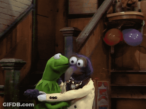 A Kermit The Frog And A Muppet Standing Next To Each Other With Balloons In The Background GIF