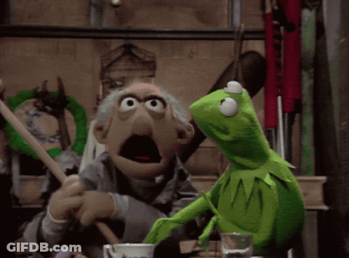 A Kermit The Frog Is Standing Next To An Old Man In A Room GIF