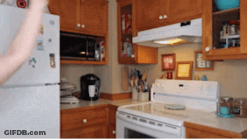A Kitchen With A Refrigerator That Has A Sticker That Says ' I Love You ' GIF