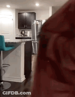 A Kitchen With A Stainless Steel Refrigerator And A Blue Bar Stool GIF