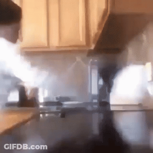 A Kitchen With Smoke Coming Out Of The Hood GIF