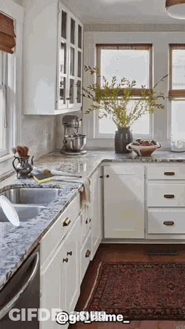 A Kitchen With White Cabinets And Granite Counter Tops And A Rug GIF
