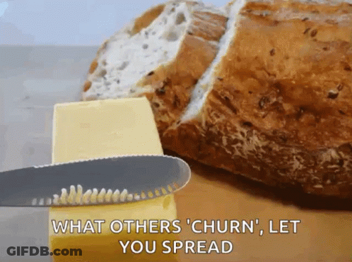 A Knife Is Spreading Butter Next To A Loaf Of Bread With The Caption What Others Churn Let You Spread GIF