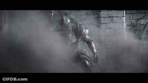 A Knight In Armor Is Holding A Spear In A Foggy Room GIF