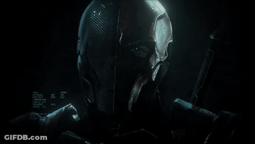 A Knight In Armor Is Holding A Sword In A Dark Room GIF