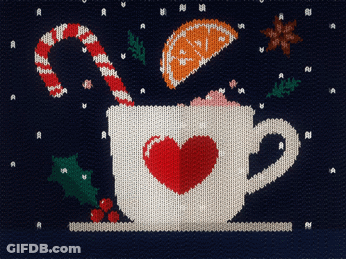 A Knitted Sweater With A Cup Of Hot Chocolate With A Heart In It GIF