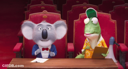 A Koala Bear And A Lizard Sit At A Table GIF