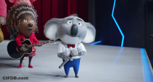 A Koala Holding A Microphone And A Guitar Standing Next To A Hedgehog GIF