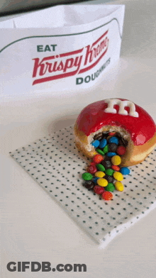 A Krispy Kreme Doughnut With A Hole In It GIF
