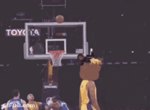 A Lakers Basketball Player Wearing A Mask Throws A Basketball Through A Hoop GIF