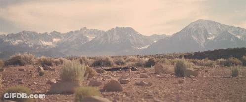 A Landscape With Mountains In The Background And Rocks In The Foreground GIF