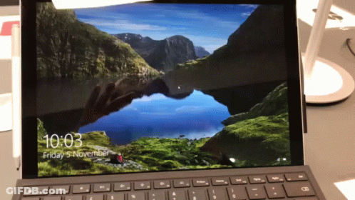 A Laptop Screen Shows The Time As 10:03 On Friday November 5 GIF