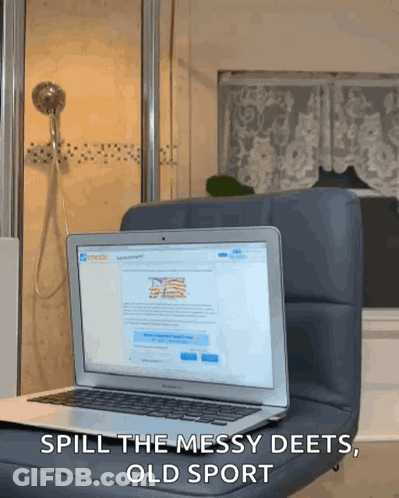 A Laptop Sits On A Chair With The Words Spill The Messy Deets Old Sport Written Below It GIF