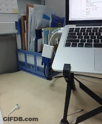 A Laptop Sits On A Desk Next To A Binder That Has A Sticker On It That Says ' A ' On It GIF