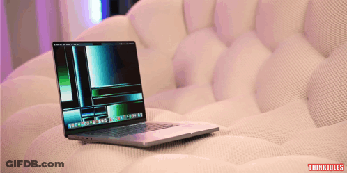 A Laptop Sits On A White Couch With Thinkjules Written On The Bottom Right Corner GIF
