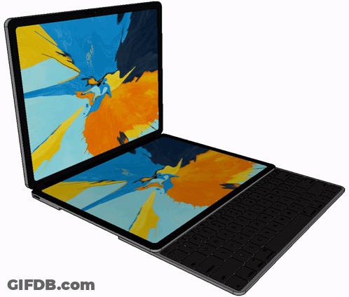 A Laptop With A Keyboard Attached To It Has A Colorful Screen GIF