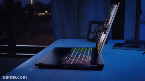 A Laptop With A Picture Of A Man And A Space Ship On The Screen GIF