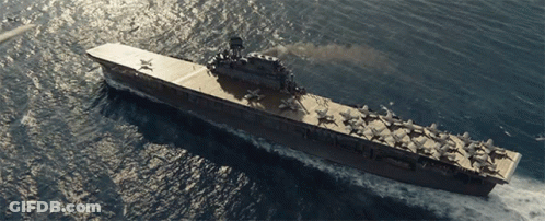 A Large Aircraft Carrier Is Floating In The Ocean With A Few Planes On The Deck GIF