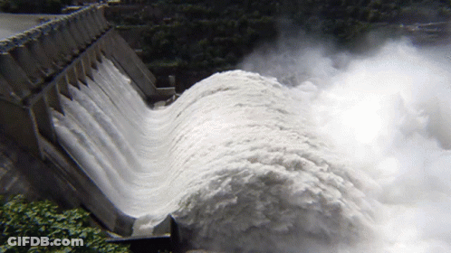 A Large Amount Of Water Is Coming Out Of A Large Dam GIF
