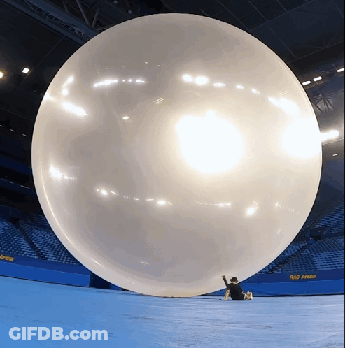 A Large Balloon In A Stadium With A Sign That Says Rio Arena On It GIF