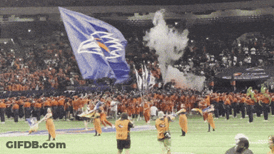 A Large Blue Flag With An Eagle On It Is Being Displayed GIF