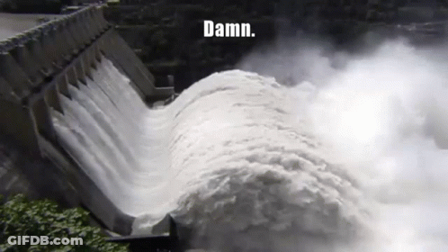 A Large Body Of Water Is Coming Down A Dam With The Words Damn Written On The Bottom GIF