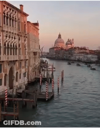 A Large Body Of Water Surrounded By Buildings And A Dome GIF