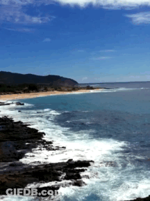A Large Body Of Water Surrounded By Rocks And Mountains GIF