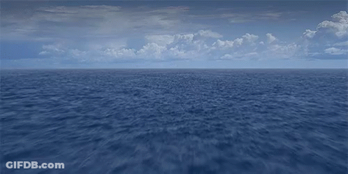 A Large Body Of Water With A Blue Sky And Clouds In The Background GIF