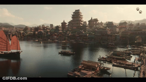 A Large Body Of Water With Boats In It And A City In The Background GIF