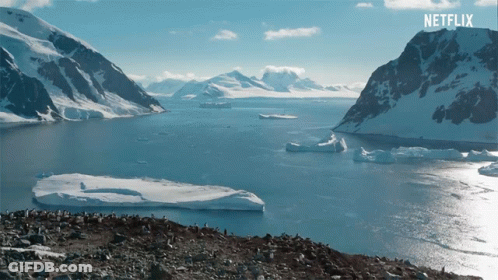 A Large Body Of Water With Mountains In The Background And A Netflix Logo On The Bottom GIF