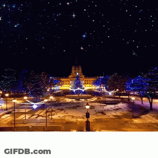 A Large Building Is Lit Up With Christmas Lights GIF