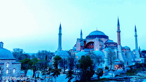 A Large Building With A Dome And A Few Minaret 'S In Front Of It GIF