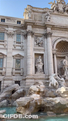 A Large Building With A Fountain In Front Of It That Says ' Triumphal Arch ' On It GIF