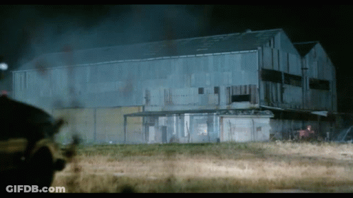 A Large Building With A Lot Of Smoke Coming Out Of It At Night GIF