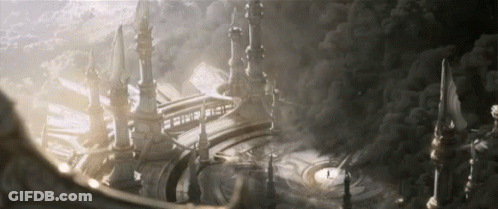 A Large Building With A Sign That Says ' A ' On It Is Surrounded By Clouds GIF