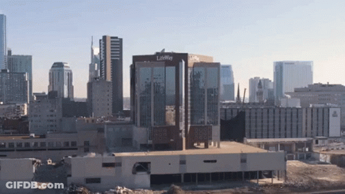 A Large Building With The Word Lifeway On It Is In The Middle Of A City GIF