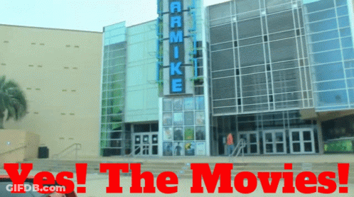 A Large Building With The Words Yes The Movies Written On It GIF