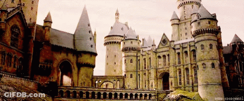A Large Castle With A Bridge In Front Of It And A Caption That Says ' Harry Potter Hogwarts ' GIF