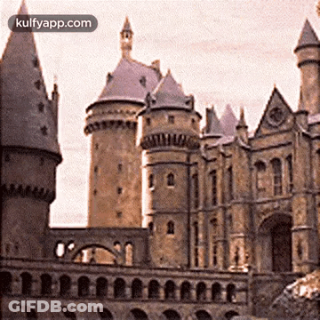 A Large Castle With A Clock On The Top Of It And The Words Kulfyapp.com At The Bottom GIF