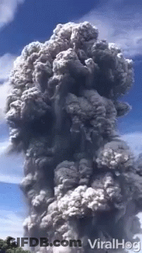 A Large Cloud Of Smoke Coming Out Of A Volcano With The Words Viralhog On The Bottom GIF