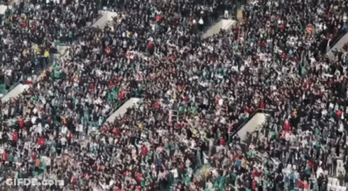A Large Crowd Of People Are Gathered In A Large Stadium GIF