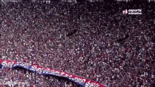 A Large Crowd Of People In A Stadium With Esporte Interactive On The Bottom Right GIF