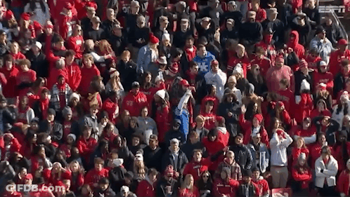 A Large Crowd Of People Wearing Red Shirts With Espn On The Bottom Left GIF