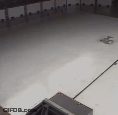 A Large Empty Room With A White Floor GIF