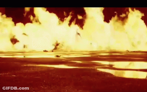 A Large Explosion In A Field With A Puddle In The Middle GIF